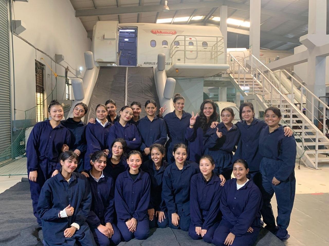 Aviation management students at an aircraft cabin simulator during practical training