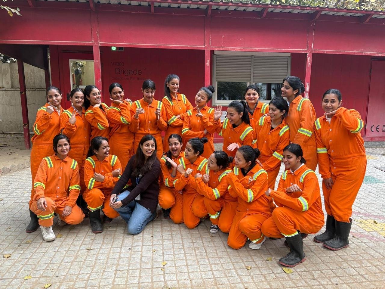 Students in fire-training coveralls during a cabin crew safety and emergency training session